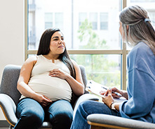 pregnant woman speaking to social worker pregnant woman speaking to social worker